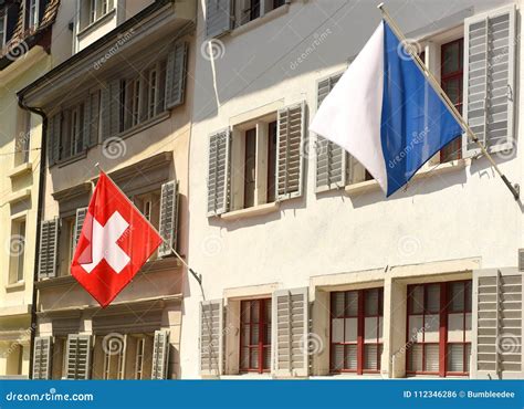 Swiss Flag and Flag of Zurich on the Facade Building in Zurich, Stock Photo - Image of ...