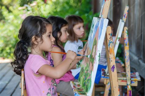 Premium Photo | Children painting a garden scene on easels