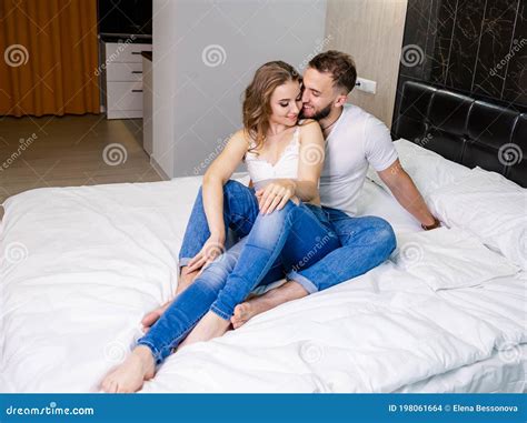 Happy Laughing Young Couple Hugging on Bed at Home. Happy Moment Stock ...