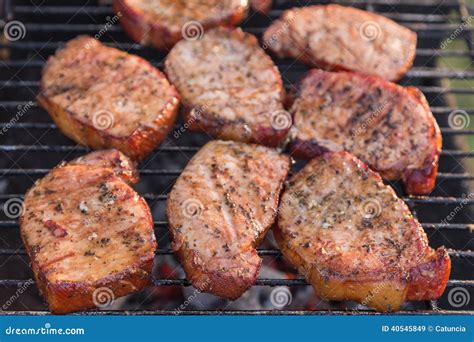 Thick Seasoned Pork Chops Cooking on the Grill Stock Image - Image of ...