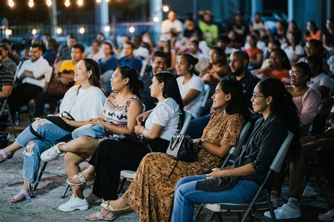 Man Wearing a White Shirt Sitting with Audience · Free Stock Photo