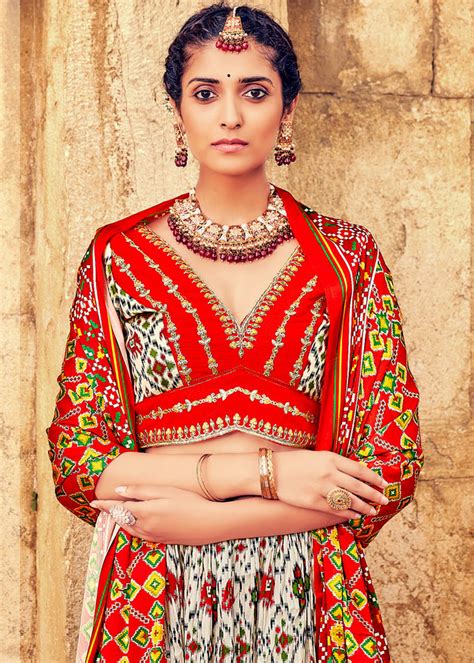 WHITE & RED HAND CRAFTED PATOLA SILK LEHENGA WITH EMBROIDERED SILK BLO ...