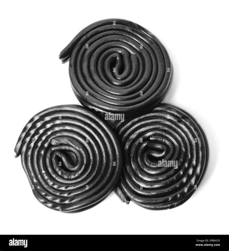 Tasty black liquorice candies on white background, top view Stock Photo ...