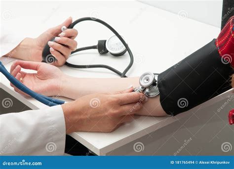 Doctor Using Sphygmomanometer with Stethoscope Checking Blood Pressure ...
