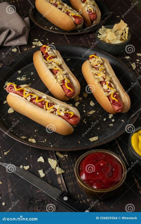 View of Hot Dogs with Ketchup and Mustard Sauce Served on a Black Plate ...