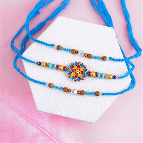 Send Triple Blue Designer Rakhis with Dry Fruits Online | Rakhibazaar.com