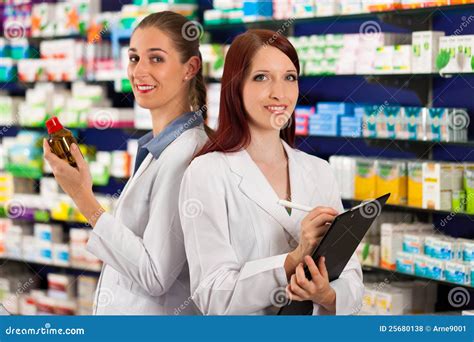 Pharmacist with Assistant in Pharmacy Stock Photo - Image of drugs, employee: 25680138