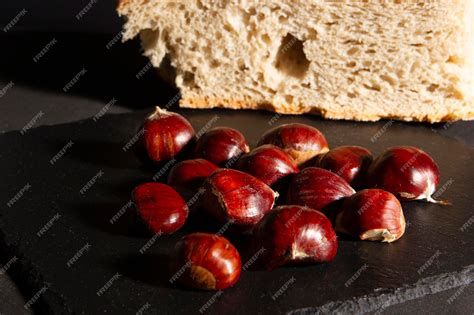 Premium Photo | Chestnuts on slate plate with traditional breadcrumb ...