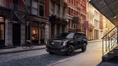 Download Stunning Cadillac Escalade making a statement on the open road. Wallpaper | Wallpapers.com