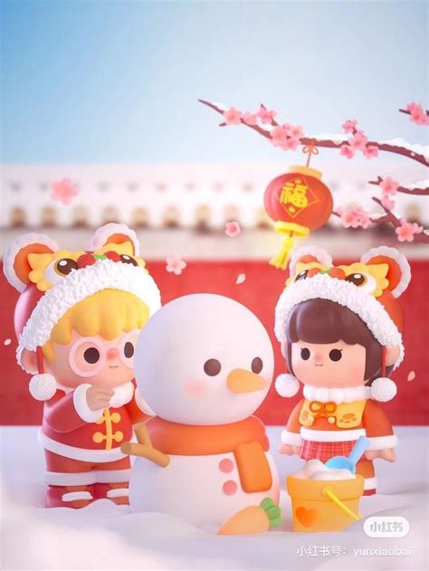 two small dolls are standing next to a snowman