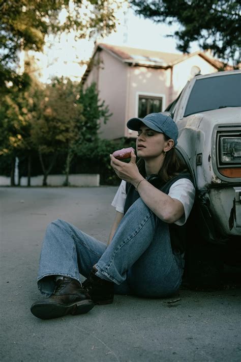 Woman in Cap Sitting on Vintage Car · Free Stock Photo