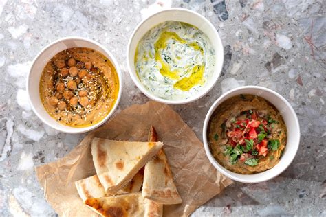 Premium Photo | Pita with assorted traditional greek dips tzatziki ...