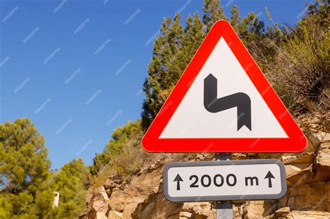 Premium Photo | A road sign marking danger curves