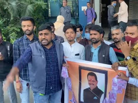 NSUI wearing a garland of rupee on the photo of Education Minister Jitu ...