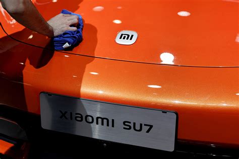 Xiaomi raises EV deliveries goal again on surging demand | Reuters
