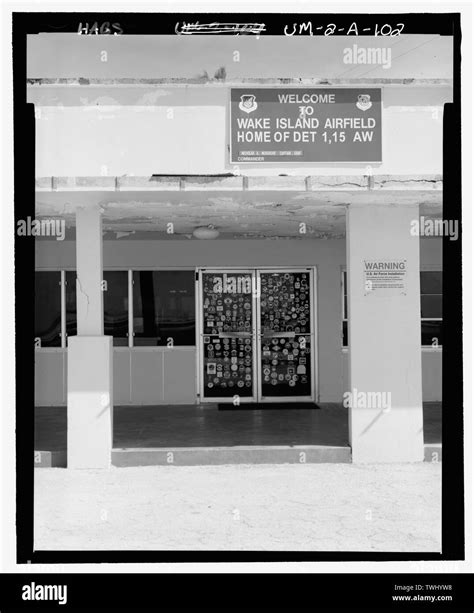 SIGN ON WEST SIDE OF BUILDING ABOVE LANAI (and-147;WAKE ISLAND AIRFIELD ...