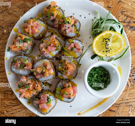 Sushi roll plate with salmon and sauce view from top. Traditional ...