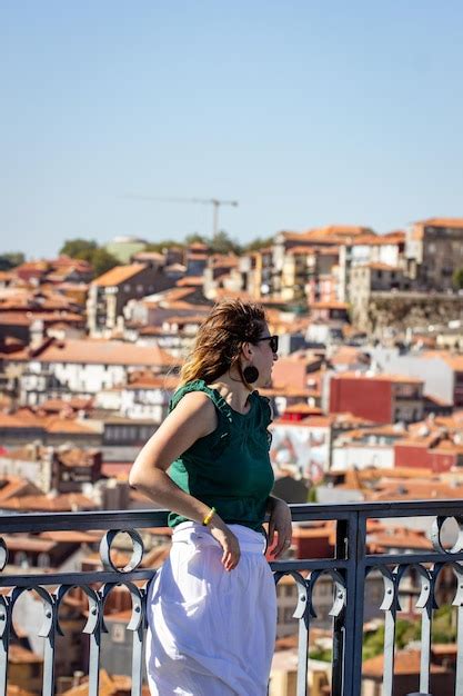 Rear view of woman looking at cityscape of porto | Premium Photo
