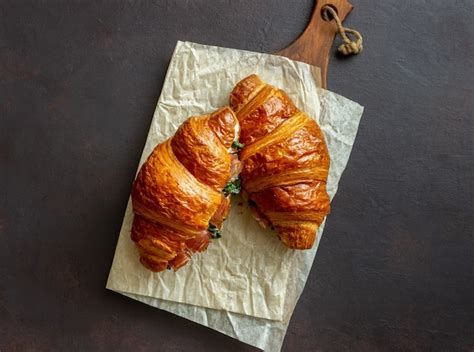 Croissants sandwiches with prosciutto, basil and white cheese. french ...