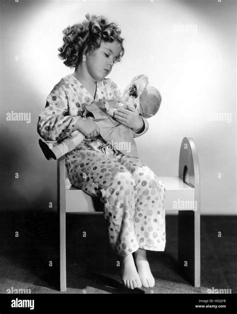 BRIGHT EYES, shirley Temple, 1934, in pajamas cradling doll" TM and ...