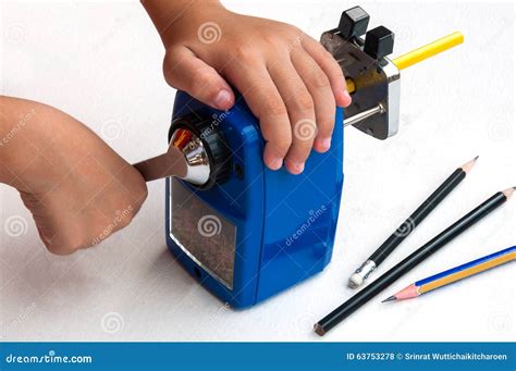 A Boy is Sharpening His Pencil Using Mechanical Sharpener Stock Photo ...