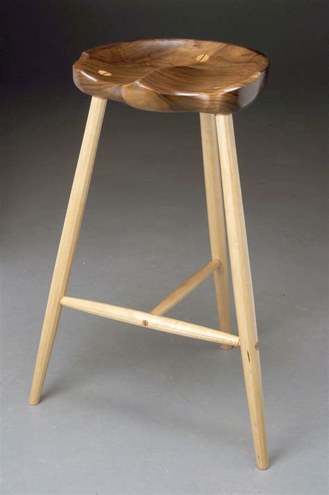 Three legged stool with faceted maple legs and walnut tractor seat ...