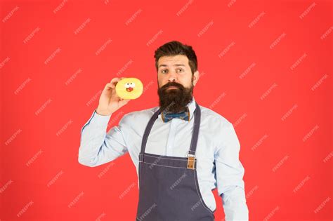 Premium Photo | Hipster bearded baker hold donuts eat donut cheerful mood doughnut calories ...