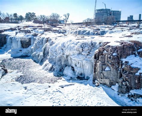 Sioux Falls Park waterfall with ice and snow. Cascading snowmelt water ...