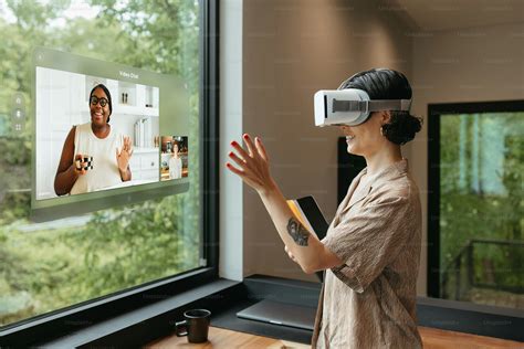 A woman standing in a kitchen wearing a virtual headset photo – Virtual ...