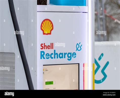 Shell Recharge logo sign on an electric car charging station. The electricity supplier is part ...