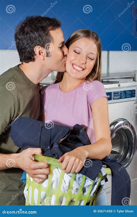 Man Kissing Woman on Cheek at Laundromat Stock Photo - Image of clothes ...