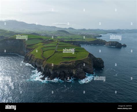 green grassland and rock land landscape of the Azores islands in the Atlantic ocean, touristic ...