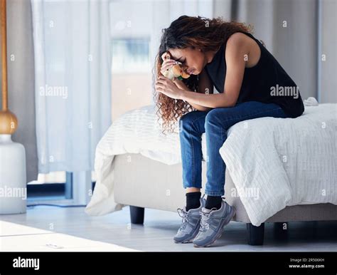 Depression, crying and woman with teddy bear in bedroom for grief ...