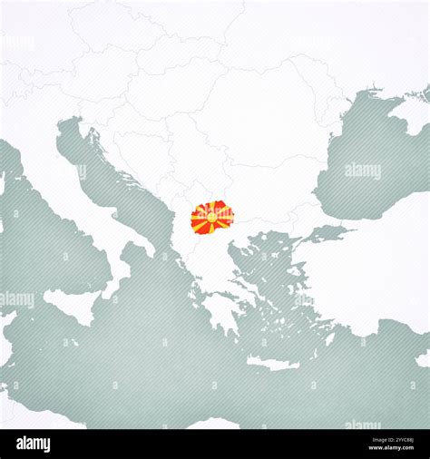 North Macedonia colored with the flag on the map of Balkans with softly striped vintage ...