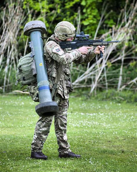A soldier is seen wielding an SA80, with a Javelin Anti-Tank Missile ...