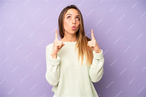 Premium Photo | Feeling awed and open mouthed pointing upwards with a ...