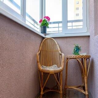 Modern Balcony Design with Modern Green Wall and Hanging Egg Chairs