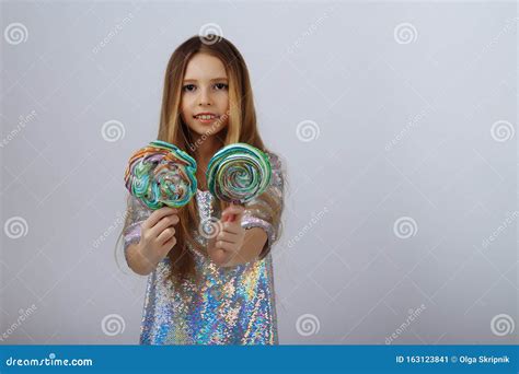 Beautiful Girl Smiles and Holds a Lolly in Her Hands. a Marshmallow ...