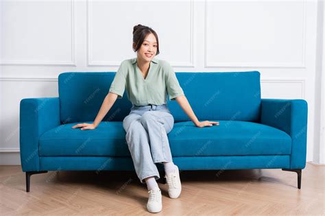 Premium Photo | Image of young Asian girl sitting on sofa at home