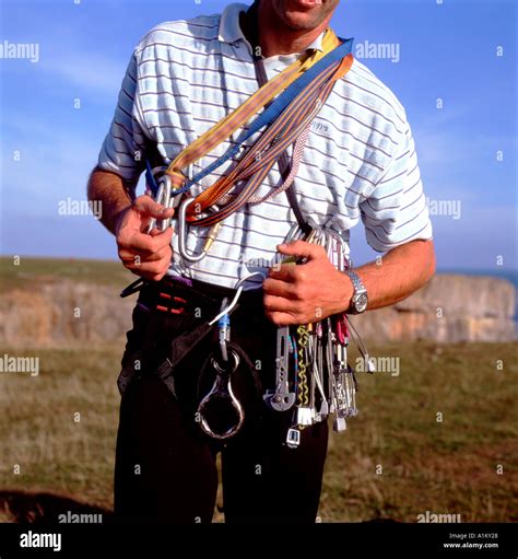 Rock climber wearing ropes tools climbing apparatus gear on chest at ...