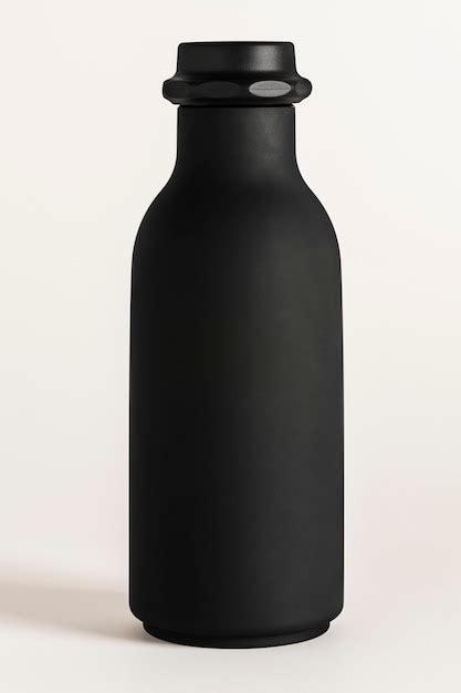 Black water bottle mockup on an off white background | Free Photo