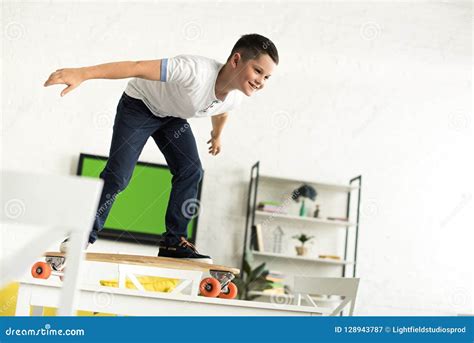 Smiling Pre-adolescent Boy Standing on Skateboard on Table Stock Image ...