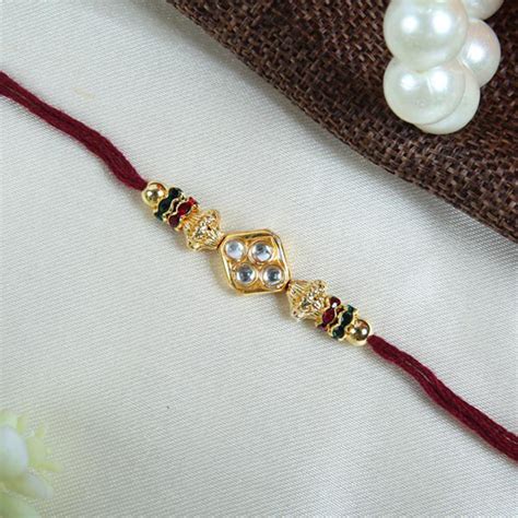 Send Elegant Cream Thread With Diamond Rakhi Online | Rakhibazaar.com