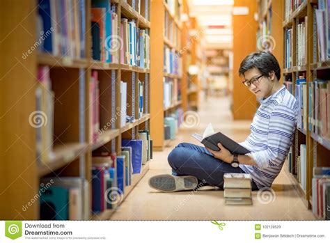 Young Asian Man University Student Reading Book In Library Stock Image ...