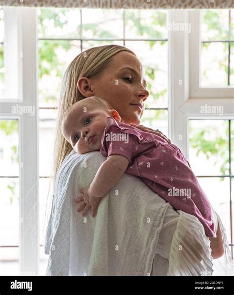 Young mother and sleeping baby Stock Photo - Alamy