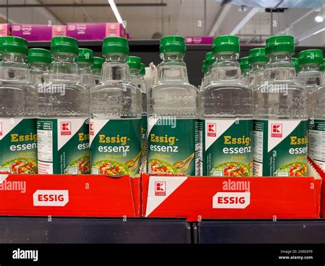 There is a row of bottles of vinegar on the shelf. The bottles are ...