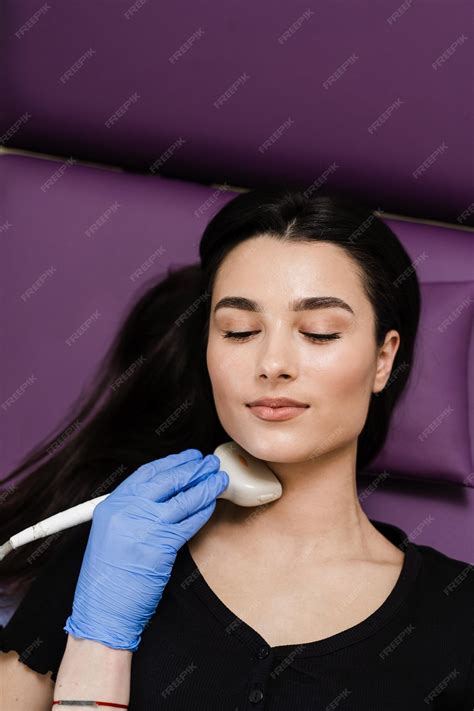 Closeup thyroid ultrasound for girl for diagnosis of tumors cysts or goiters of the thyroid in ...