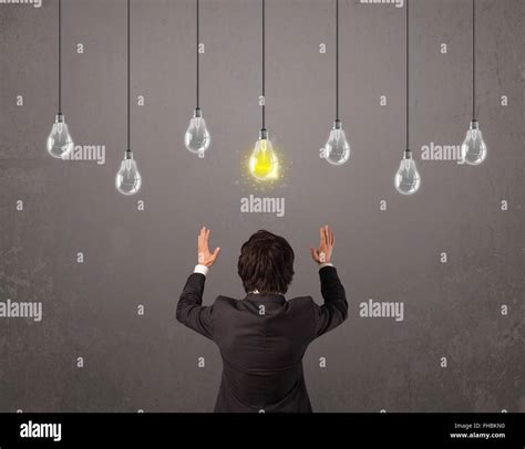 Businness guy in front of idea light bulbs concept Stock Photo - Alamy