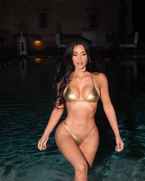 Kim Kardashian bikes in a gold bikini in sexy 'night swim' snaps