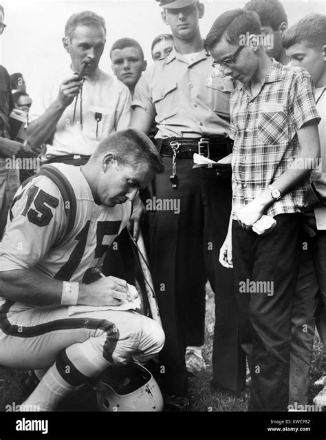 Buffalo Bills player Jack Kemp signs his autograph for a boy on August ...